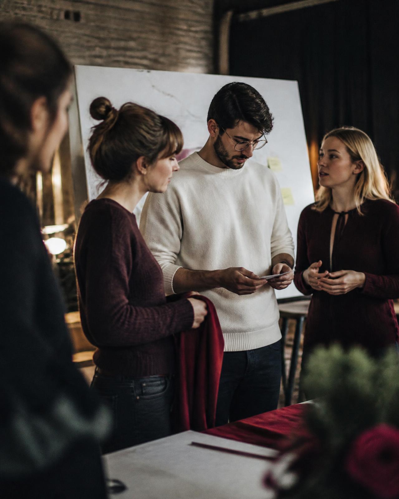 A small team reviewing campaign materials in a dim loft workspace